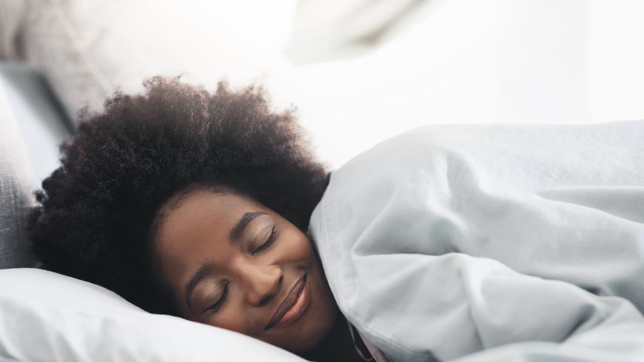 woman sleeping in crisp white sheets 