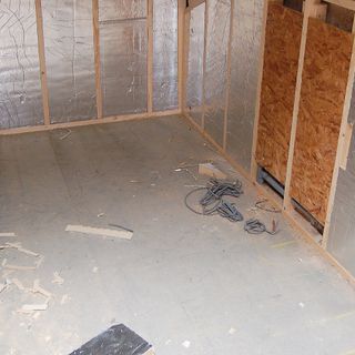 A large loft space with wood framing and insulation