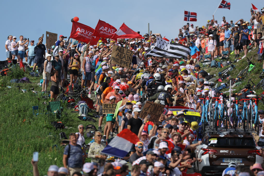 Jumbo-Visma's Danish rider Jonas Vingegaard wearing the overall leader's yellow jersey and Bahrain - Victorious' Spanish rider Pello Bilbao cycle in the crowded ascent of Col de la Loze in the final kilometres of the 17th stage of the 110th edition of the Tour de France cycling race, 166 km between Saint-Gervais Mont-Blanc and Courchevel, in the French Alps, on July 19, 2023. (Photo by Thomas SAMSON / AFP)