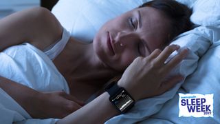 A woman sleeps well on a comfy mattress while wearing a smartwatch to track her sleep