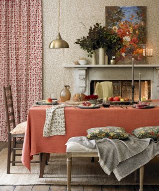 Fall mantel ideas with a marble mantelpiece, wooden and golden ornaments and orange and blue autumnal painting