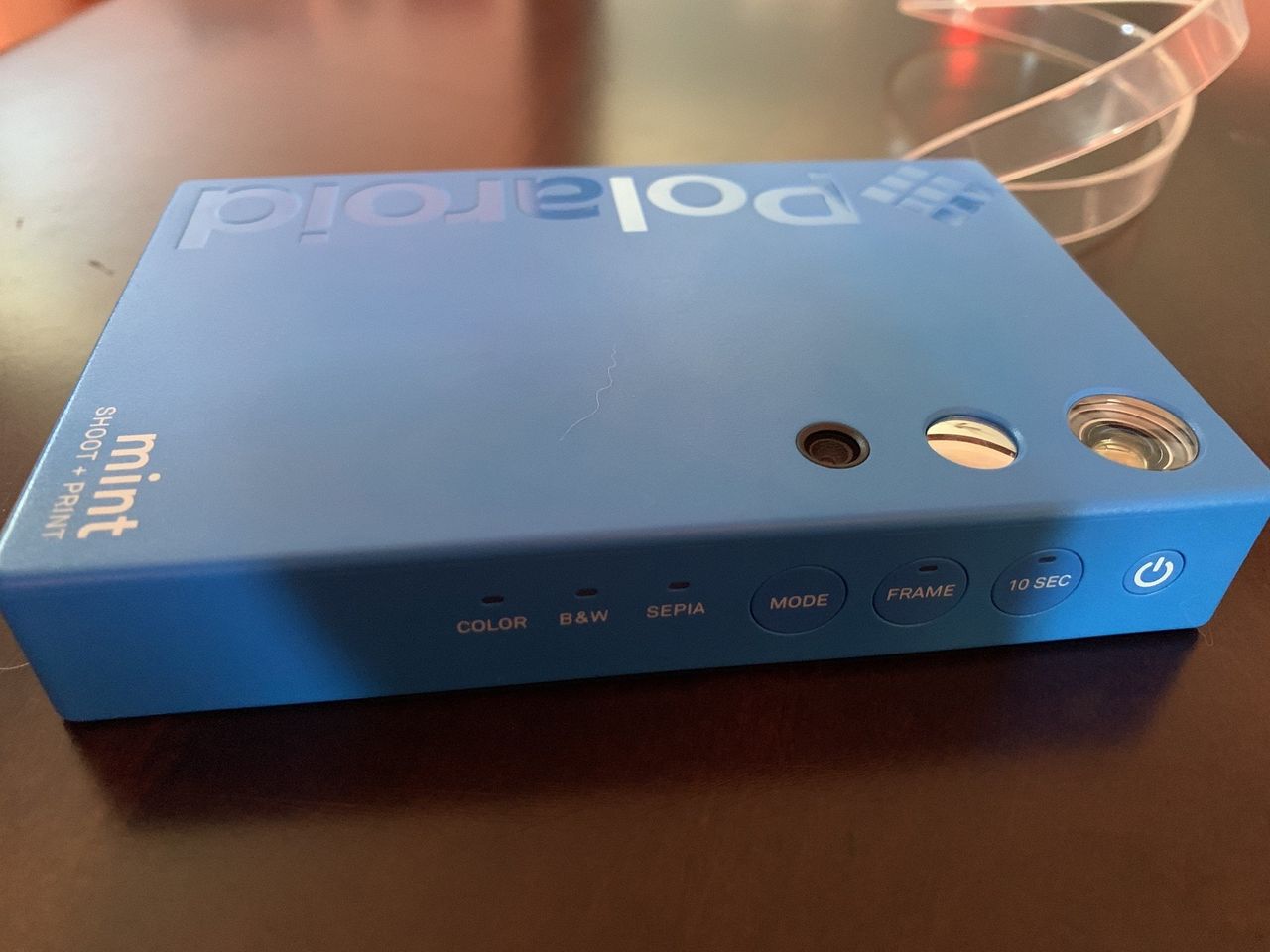 Blue Polaroid Mint Camera &amp; Printer side where color modes, frame and timer buttons