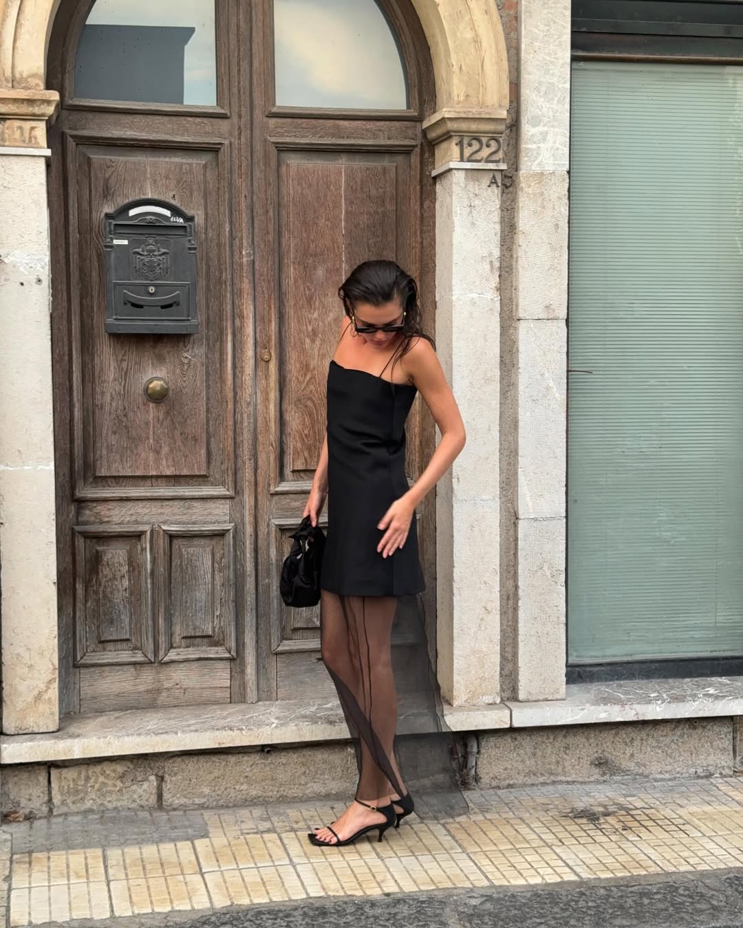 Valeria in a black dress with a sheer skirt
