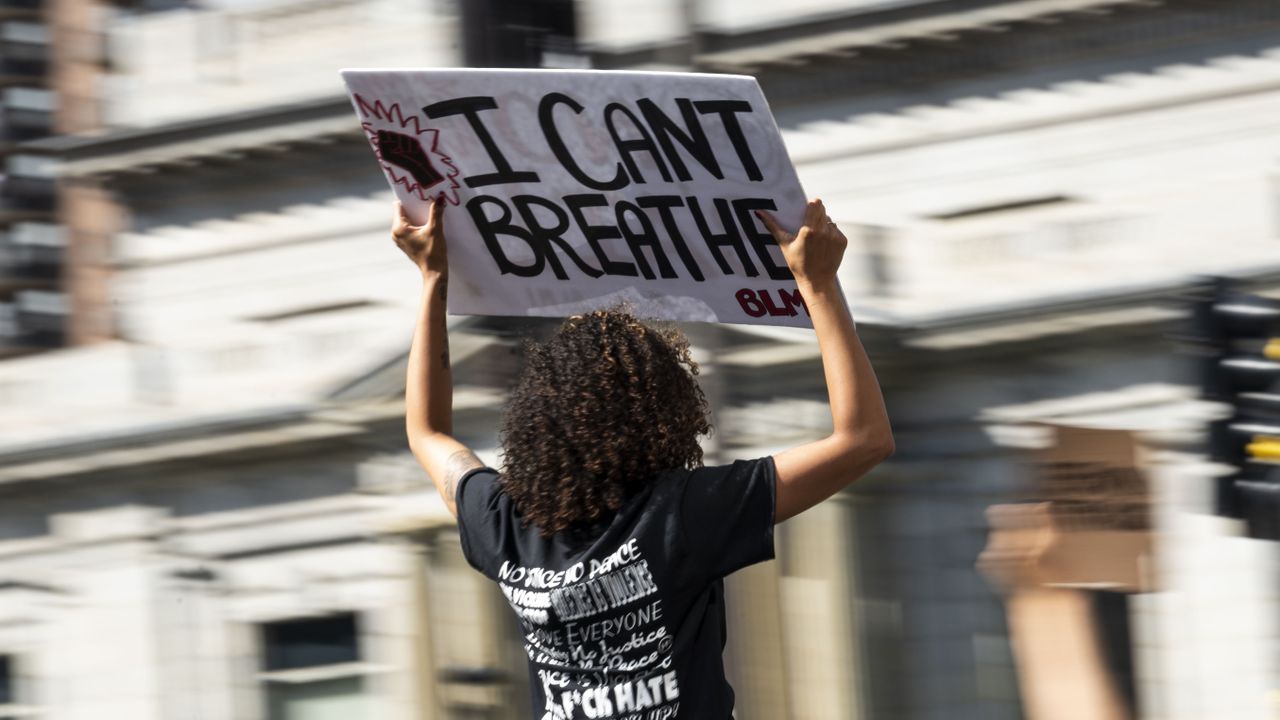 minneapolis, mn may 31 a person holds a sign as a crowd marches through downtown to protest the death of george floyd on may 31, 2020 in minneapolis, minnesota the protest was disrupted after a man drove a tanker truck into the crowd photo by stephen maturengetty images