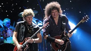 Jamie Moses and Brian May playing on stage