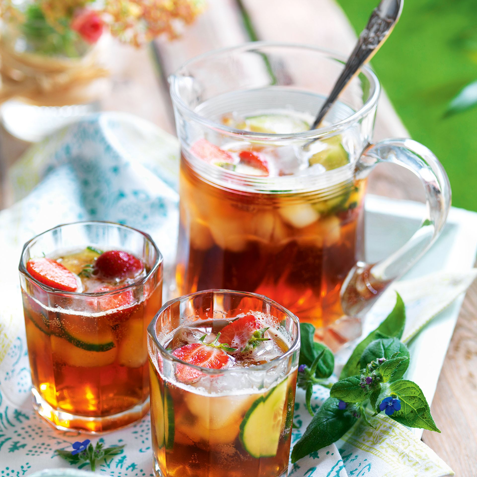 Jug and glasses of Pimms in garden