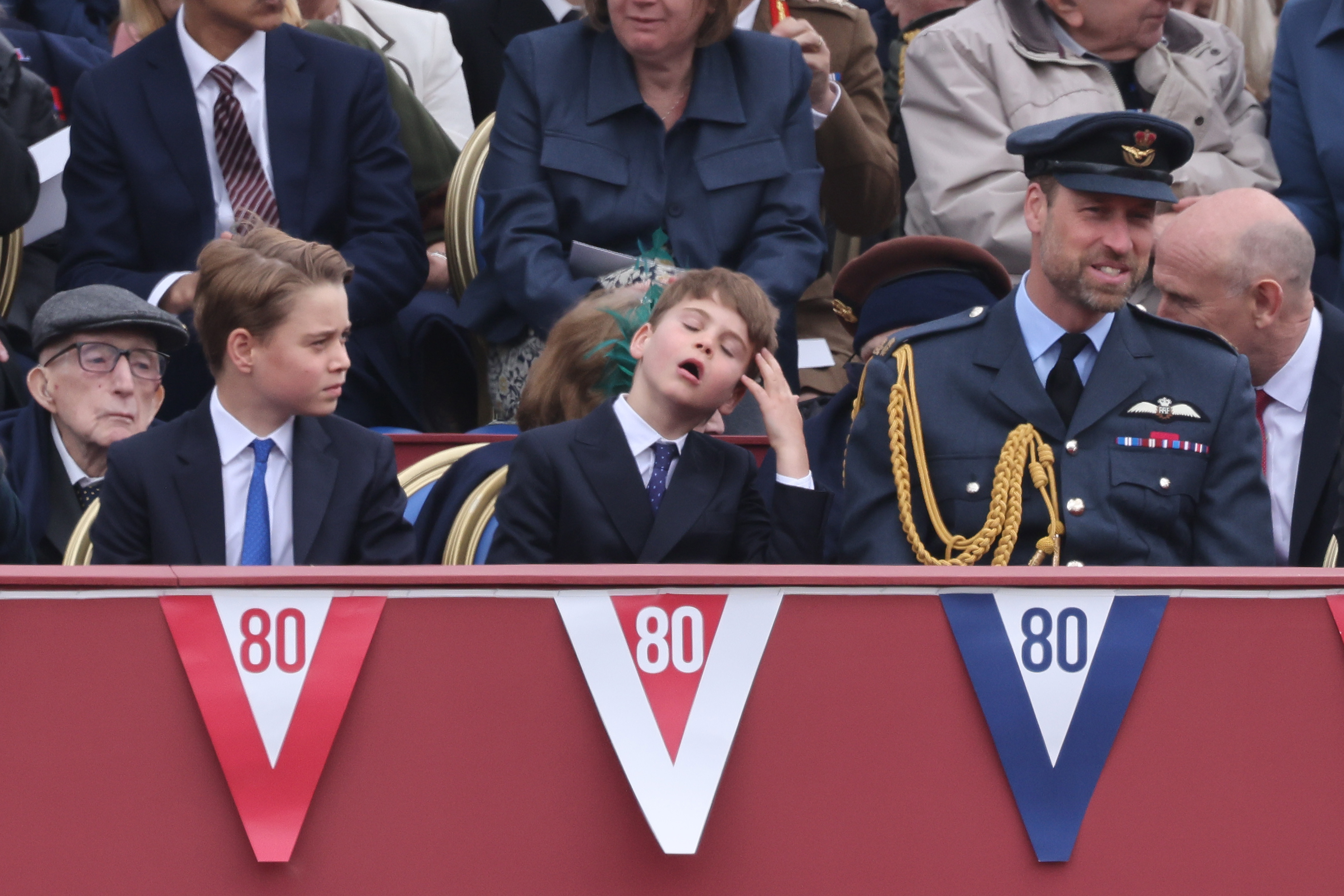 Prince Louis imitating Prince George's hair flip during the VE Day 80 parade with Prince William