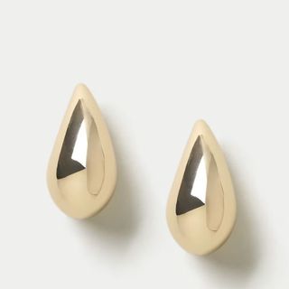 flat lay image of gold earrings