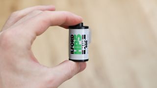 Ilford HP5 Plus 35mm film canister held in a hand