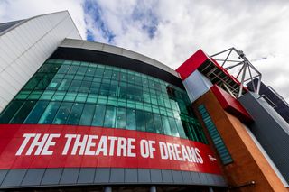 A general exterior view of signage on the Stretford end stand at Old Trafford during Manchester United's FA Cup quarter-final against Liverpool in March 2024.