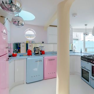kitchen room with kitchen cabinets and pink fridge