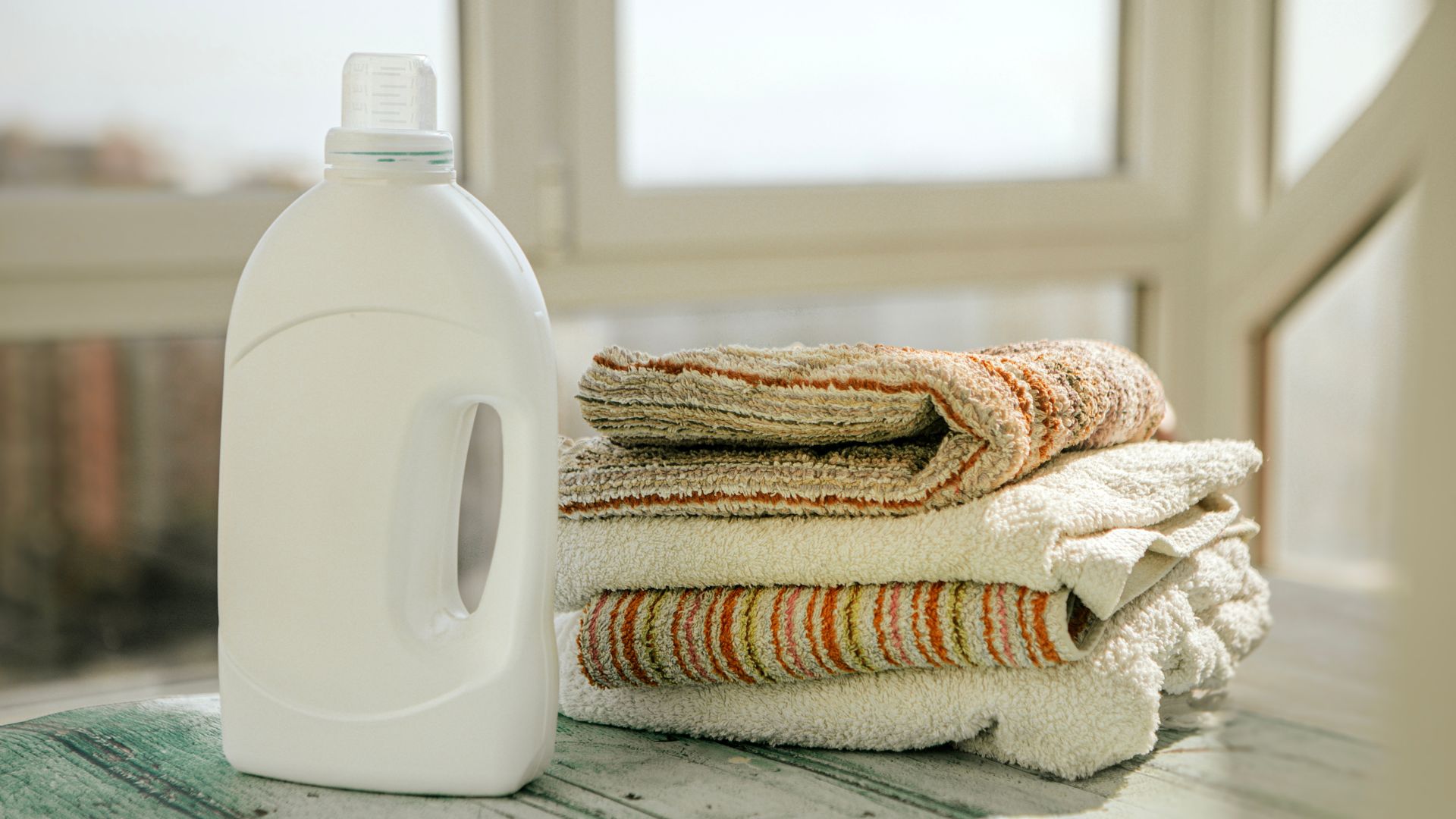 picture of washing detergent and cleaned towels on countertop