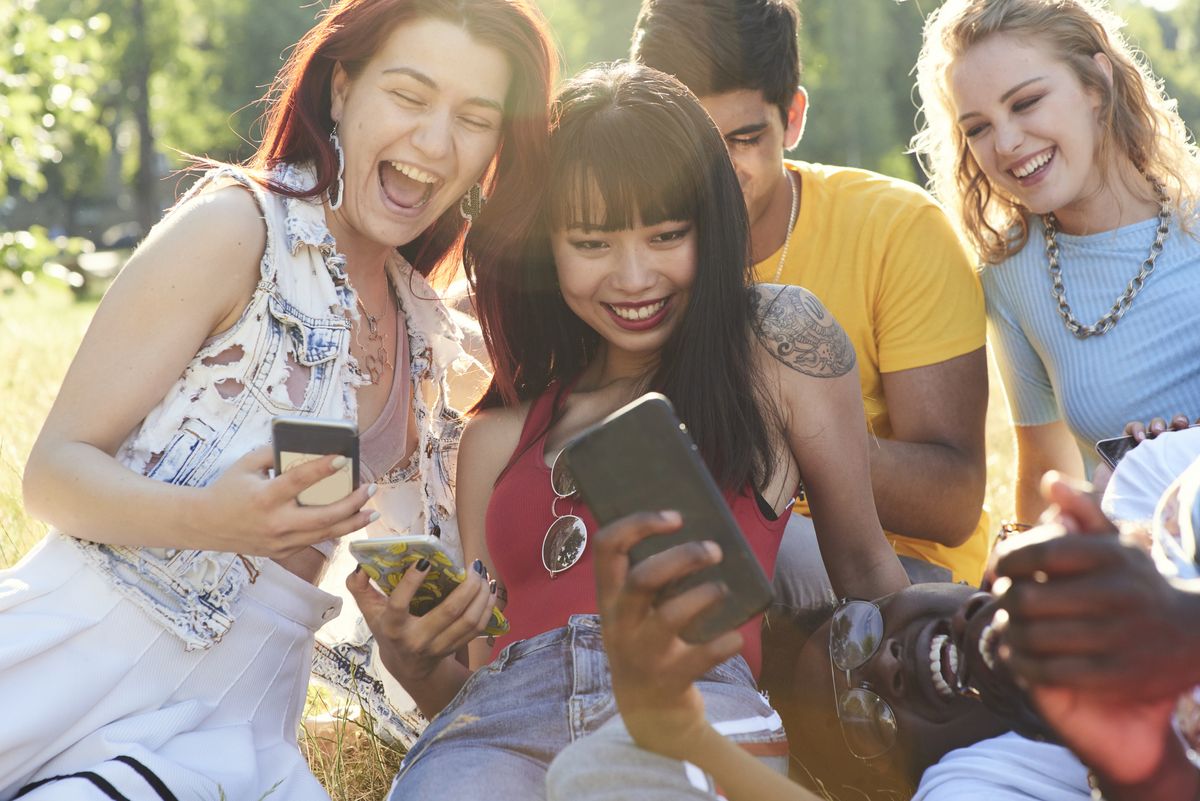 Friends laughing at their phones
