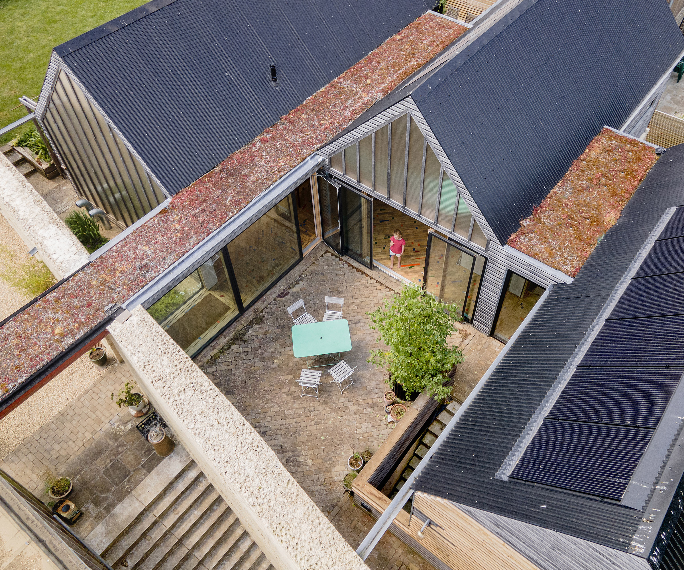An aerial drone shot of three self build buildings