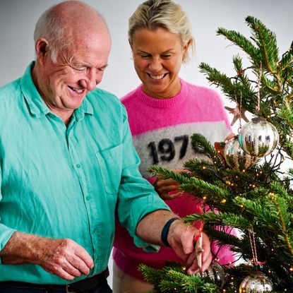 Rick Stein with his wife decorating a christmas tree with a star