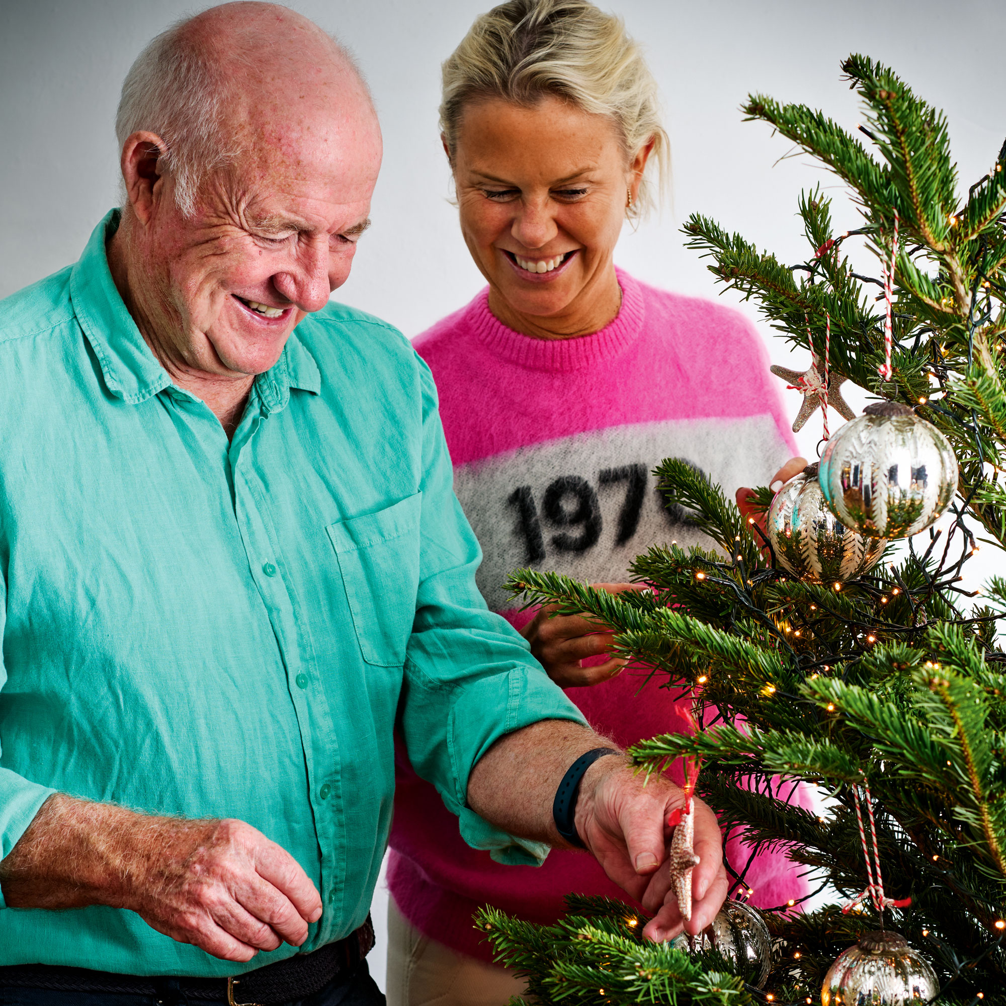 Rick Stein with his wife decorating a christmas tree with a star