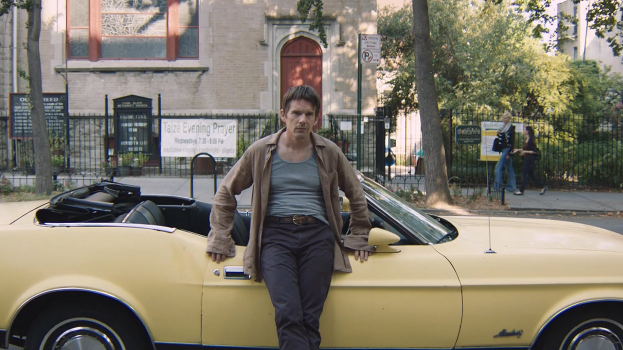 Ethan Hawke standing in front of a yellow convertible in Cymbeline