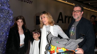 Kate Garraway and Derek Draper with their children at the airport