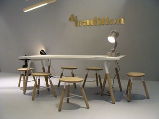 Table with stools around it and a lamp