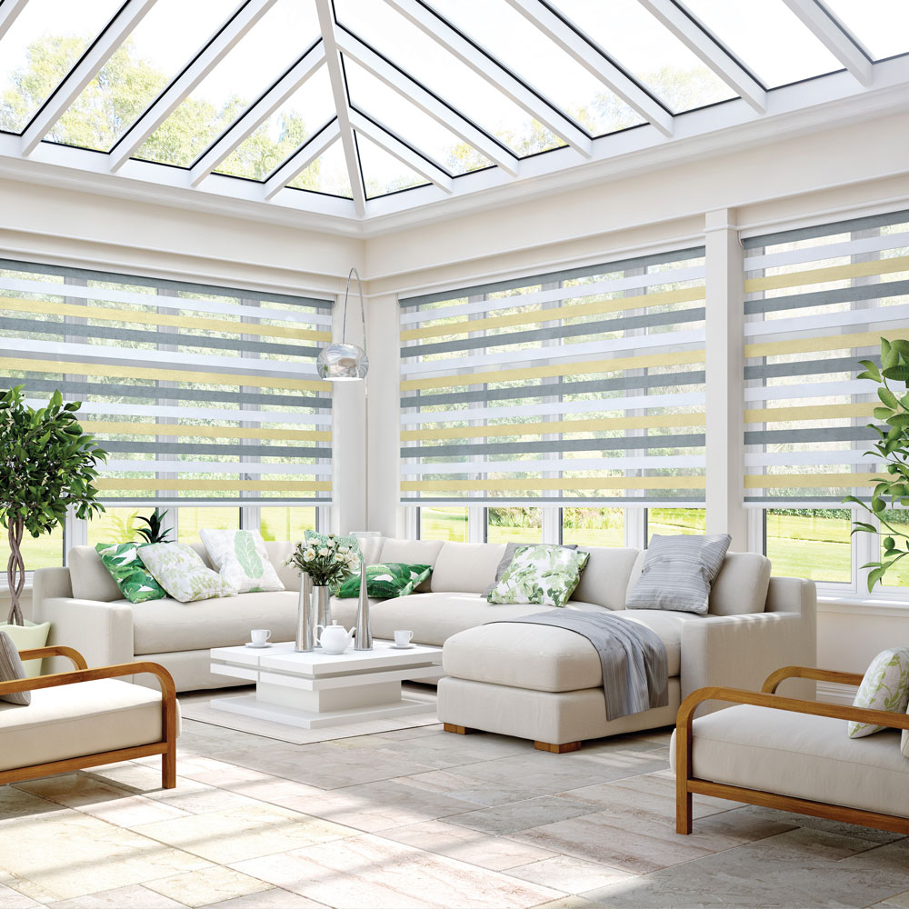A spacious conservatory with yellow and grey striped blinds