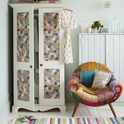 room with white walls white wardrobe and printed wall 