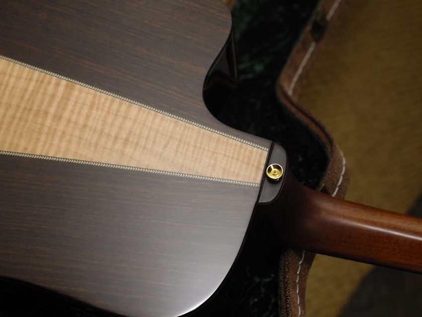 The back insert is a striking flash of flamed maple.