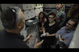 NASA astronaut Mike Massimino shows recording artist Skrillex the inside of a mock up of a space shuttle. Image released May 8, 2013