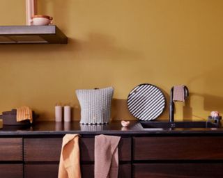 Yellow kitchen with black countertops