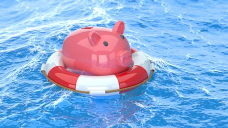 A piggy bank balanced on a lifesaver in rough blue water.