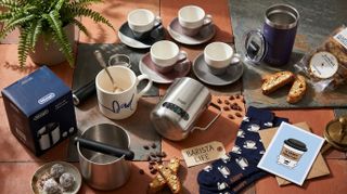 Collection of coffee accessories and Father's Day card on wooden counter