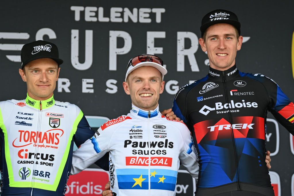 Belgian Quinten Hermans Belgian Eli Iserbyt and Belgian Toon Aerts celebrate on the podium after the men elite race of the Cyclocross Ruddervoorde the second stage of the Superprestige cyclocross cycling competition Saturday 23 October 2021 in Ruddervoorde Oostkamp BELGA PHOTO DAVID STOCKMAN Photo by DAVID STOCKMANBELGA MAGAFP via Getty Images