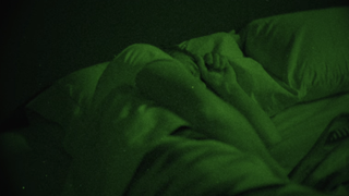 Screenshot of John Dutton asleep through night vision In Yellowstone Season 5