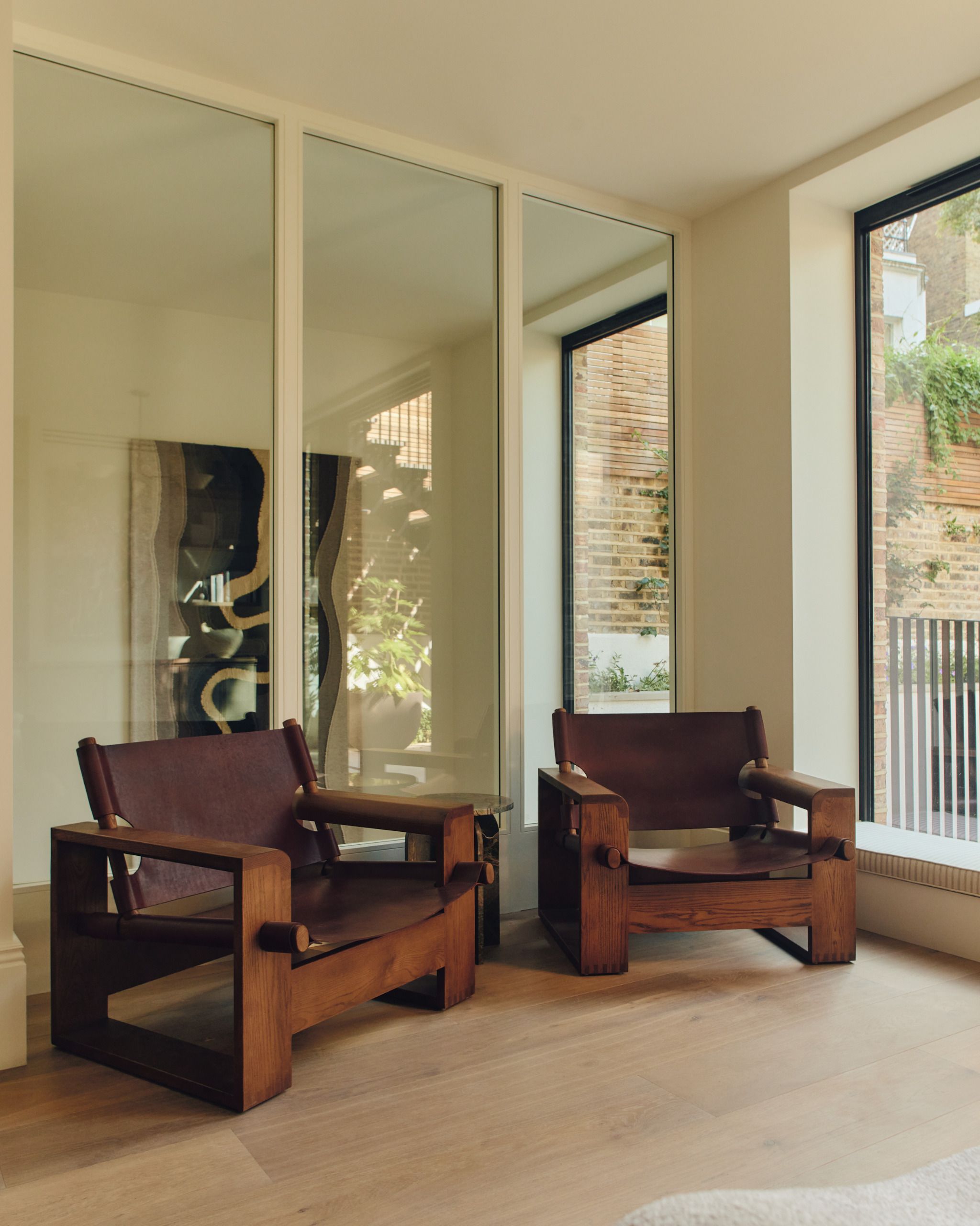 View of kitchen seating area and glazed partition with hanging tapestry