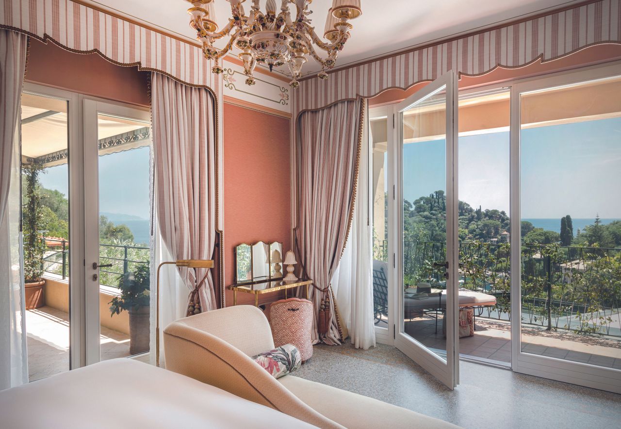 Inside La Baronessa suite, huge glass doors open up onto a balcony overlooking Portofino