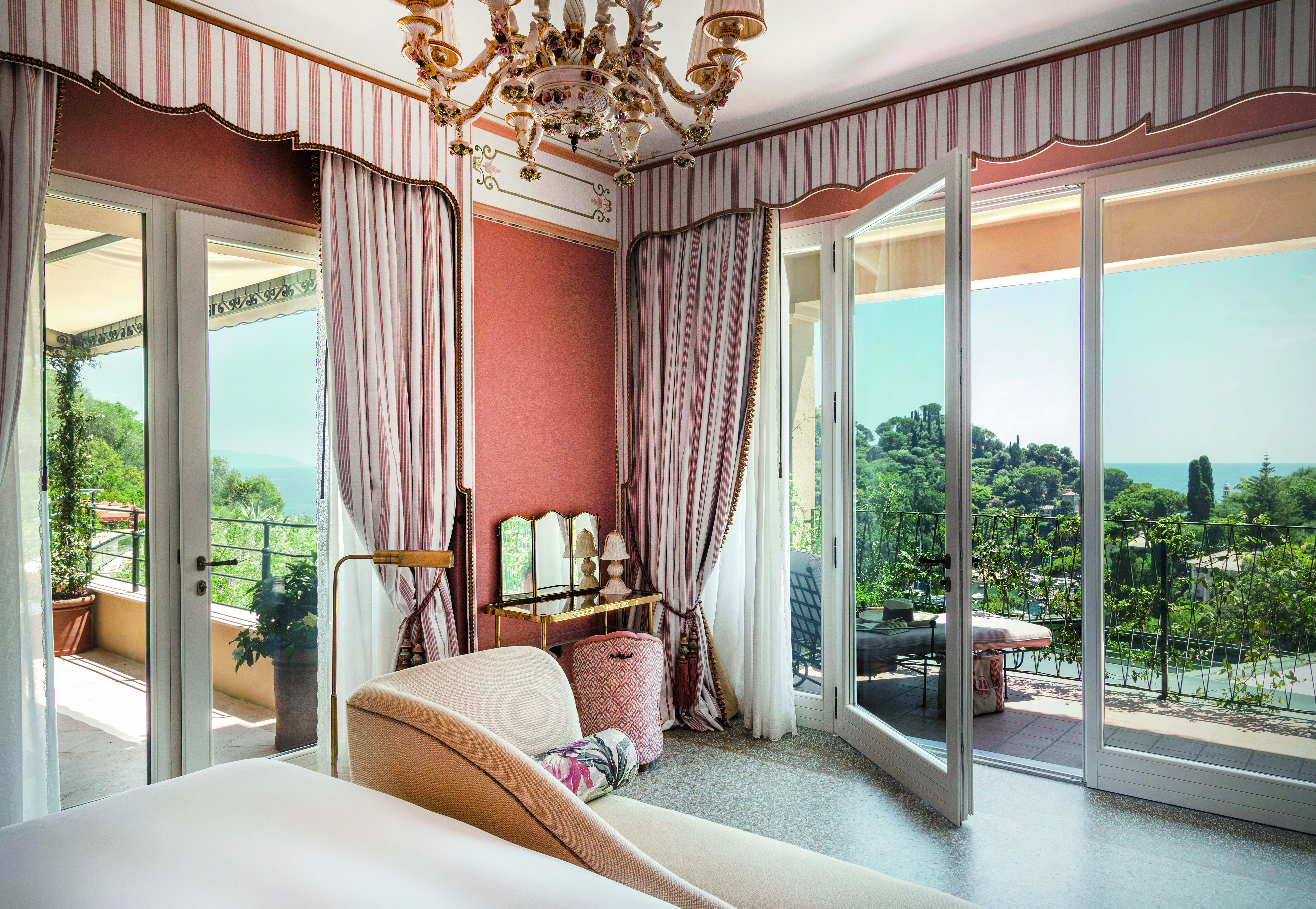 Inside La Baronessa suite, huge glass doors open up onto a balcony overlooking Portofino
