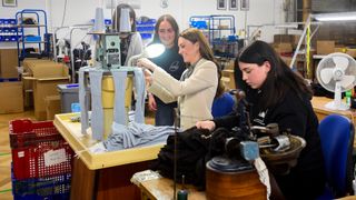 Catherine, Princess of Wales spends time with members of the production team on the factory floor during a visit to Corgi