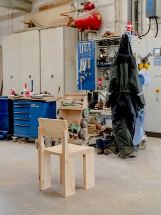 A dining chair in pine wood on the factory floor