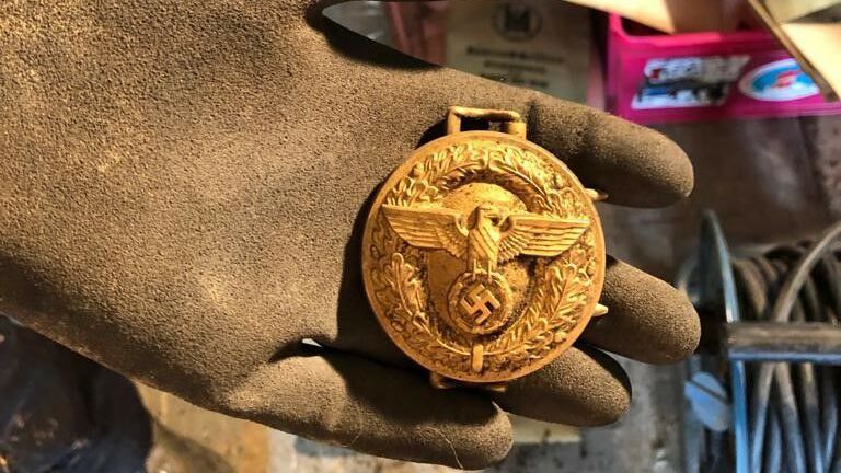 Badges and medals with Nazi party symbols &ndash; such as eagles bearing swastikas &ndash; were found in the hoard.