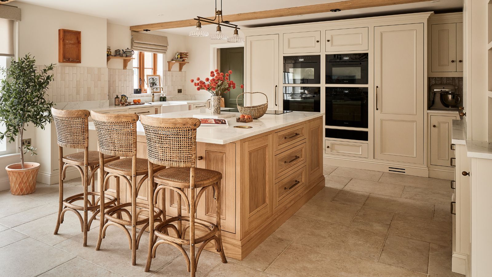 A neutral kitchen with a wooden island