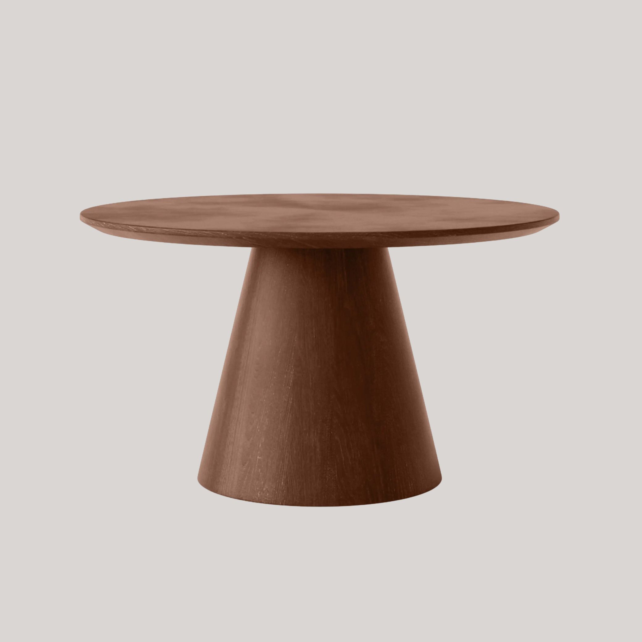 A round coffee table in chocolatey wood with a slanted, chubby base sits against a pale gray background.