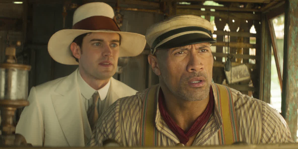 MacGregor Houghton (Jack Whitehall) stands behind Frank Wolff (Dwayne Johnson) in a scene from &#039;Jungle Cruise&#039;