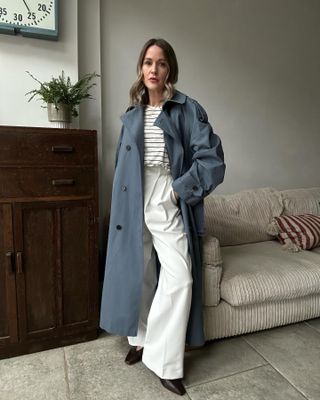 What to wear in October: @maimy_pea wears a trench coat with tailored trousers and flats