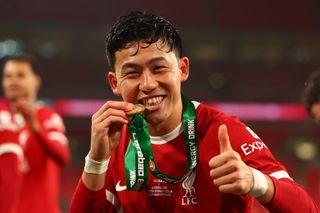 Wataru Endo of Liverpool celebrates at the end of the Carabao Cup Final match between Chelsea and Liverpool at Wembley Stadium on February 25, 2024 in London, England.
