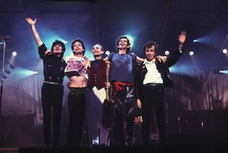 The Rolling Stones wave from the stage following a performance during their 'Steel Wheels' tour, late 1989