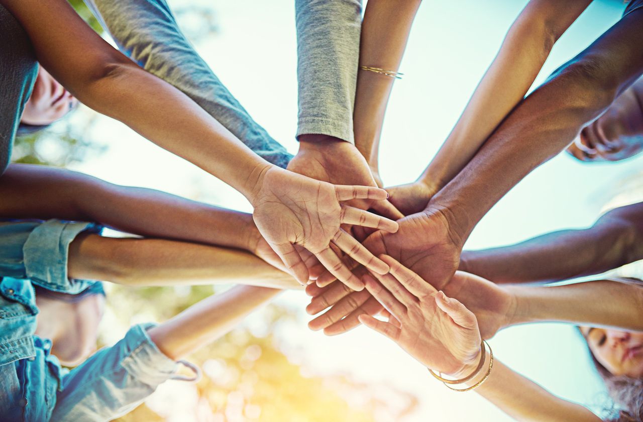 Cropped shot of a group of friends with their hands piled on top of each other