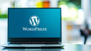 Laptop computer displaying logo of WordPress, a free and open-source content management system (CMS)