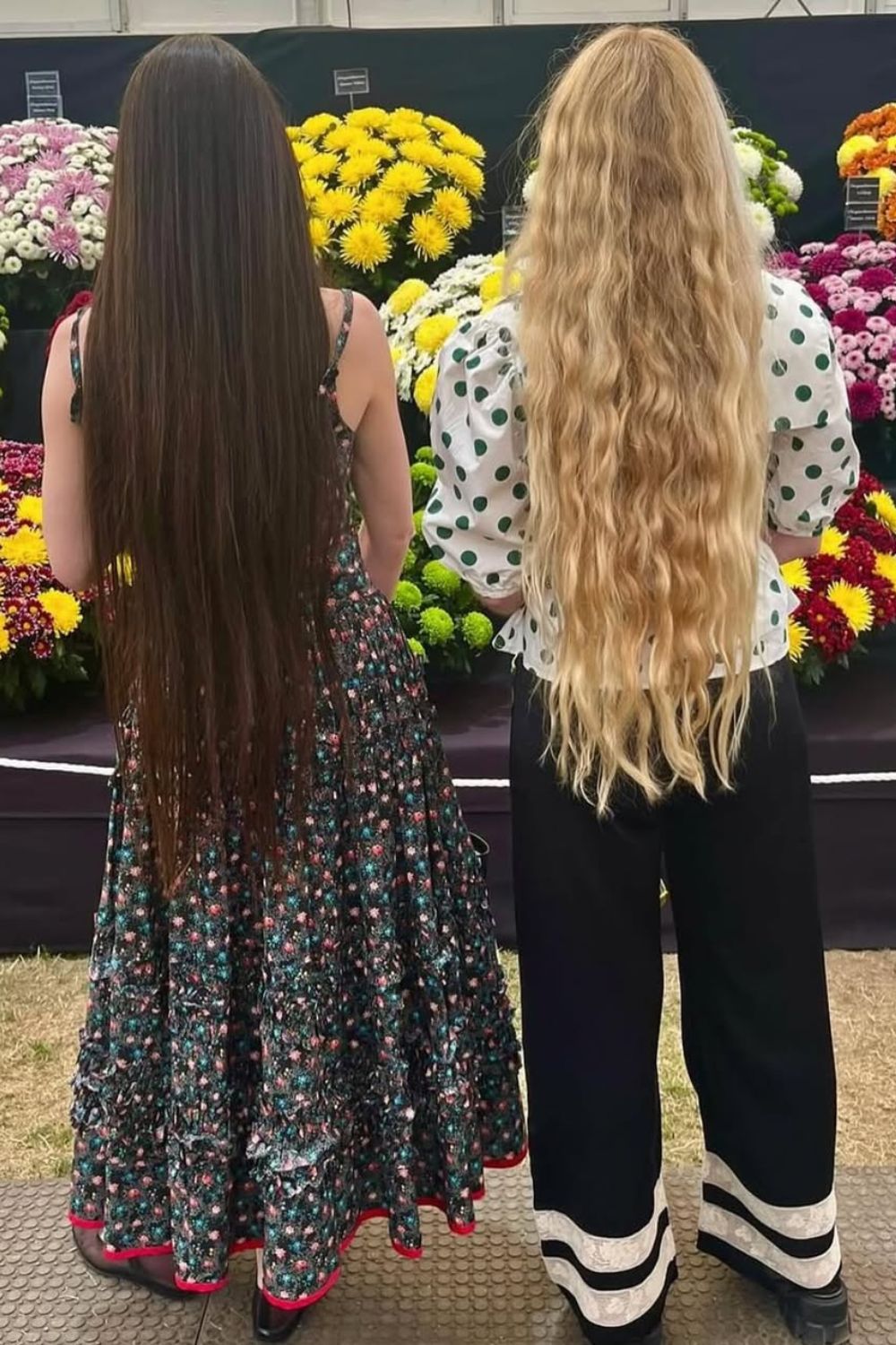 Daisy Hoppen and Hannah Weiland facing away from the camera showing off their mermaid hair