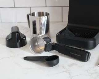 Mr. Coffee Steam Espresso Maker accessories on white marble kitchen countertop