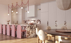 Cara Woodhouse Interiors kitchen with marble island and countertop details, pink modern stools and linked pink chain pendant lighting above and a round dining table with cream circular detail chairs