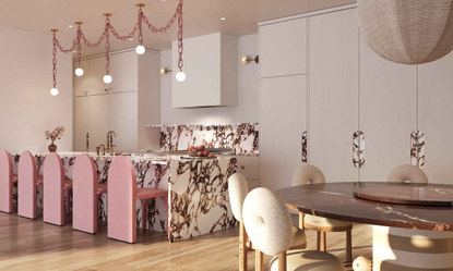 Cara Woodhouse Interiors kitchen with marble island and countertop details, pink modern stools and linked pink chain pendant lighting above and a round dining table with cream circular detail chairs
